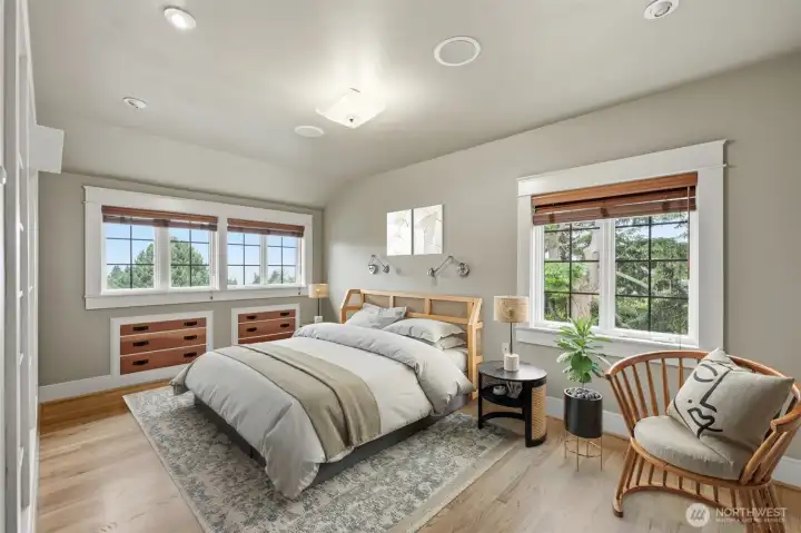 Primary bedroom with views. Reading lamps all ready installed and built in drawers.   Virtually staged.