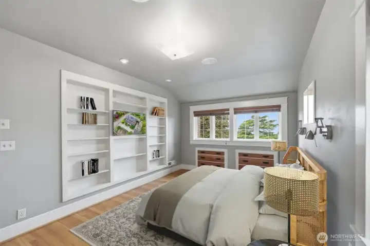 Primary bedroom with a large book shelve for your favorite books.  Virtually staged.