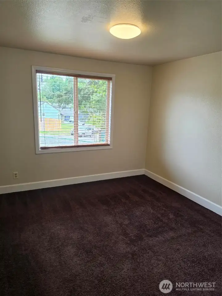 Bedroom one looking out to front of duplex.