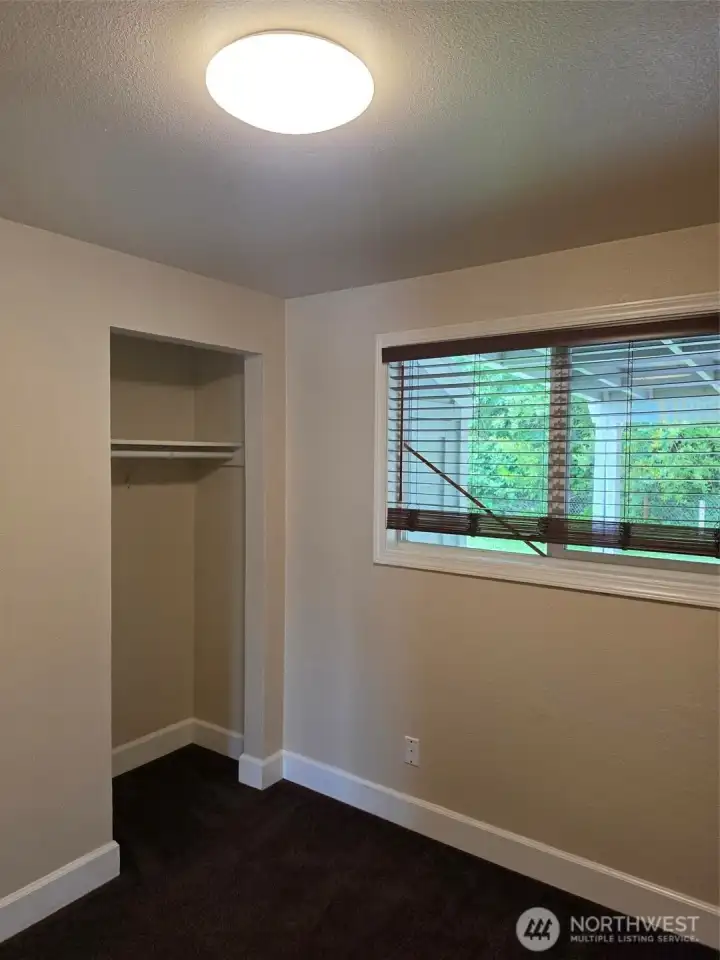 Bedroom three closet and looking out on covered patio in back yard.