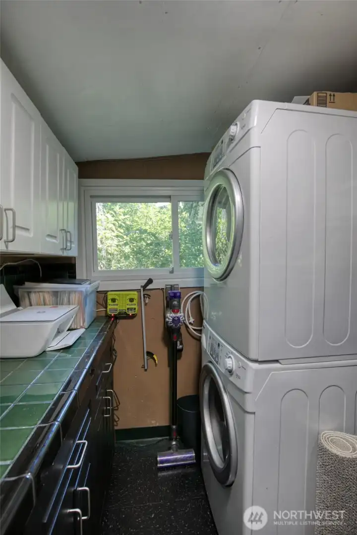 Full size washer and dryer and ample counter and storage space