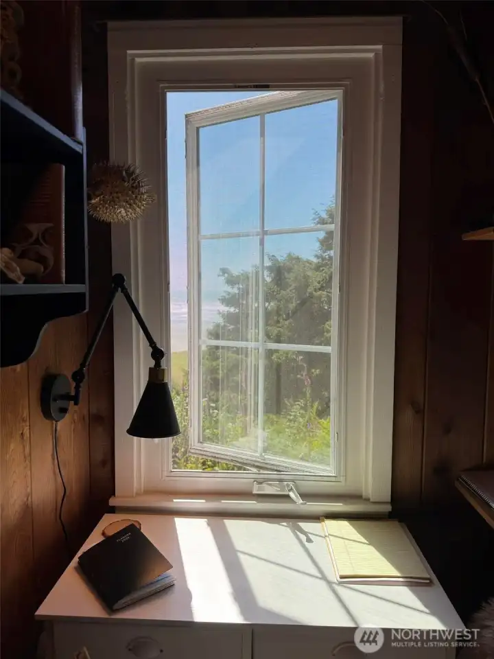Small room featuring a writing desk and a twin bed to get away from it all