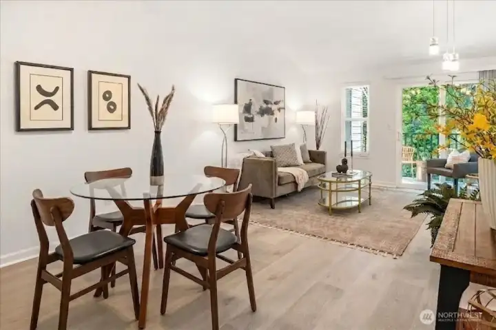 Bright open-concept living and dining spaces welcome you home with soaring vaulted ceilings and luxury vinyl plank floor.