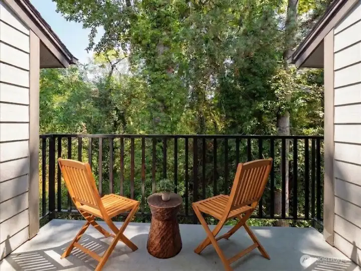 Unwind on this serene, tree-lined balcony with a private storage closet.