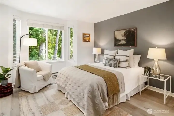 Tranquil primary bedroom filled with natural light, creating a comfortable and relaxing retreat.