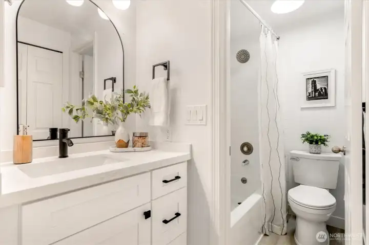 Updated en-suite bathroom showcasing modern finishes and a functional design.