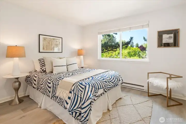 Bright and versatile secondary primary bedroom with large private window and abundant natural light.