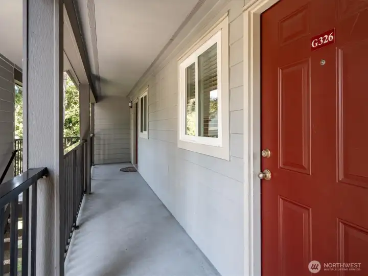 Welcoming covered entryway with access at the end of the hallway.