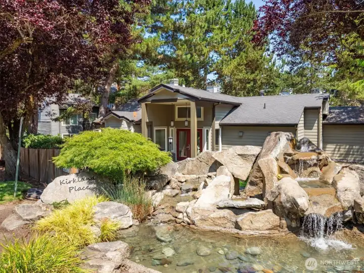 Beautifully landscaped community grounds featuring tranquil water features and mature trees.
