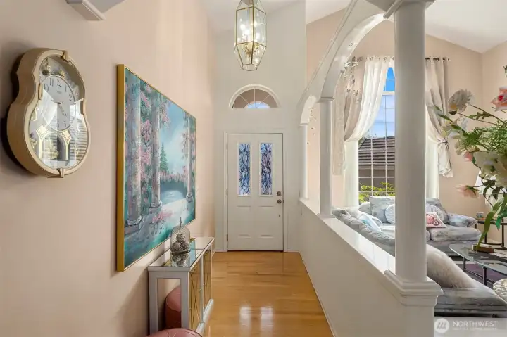 Entryway leading to living/dining room with vaulted ceilings.