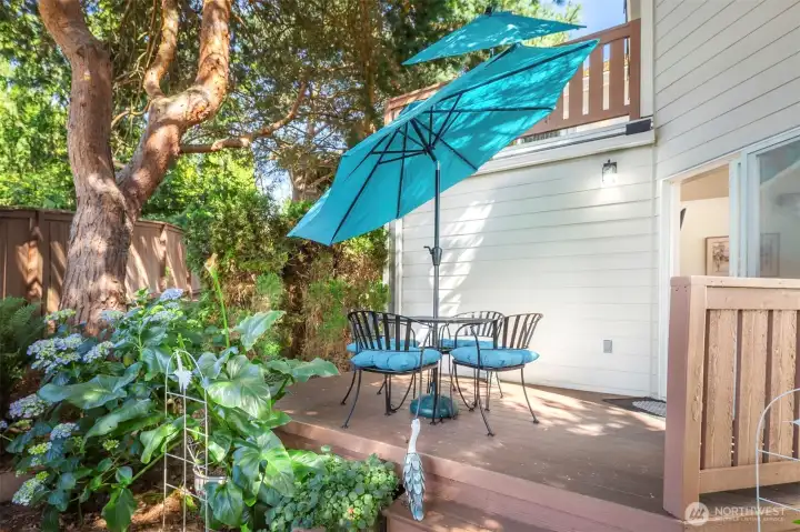 Back deck off of living space through sliding glass doors.