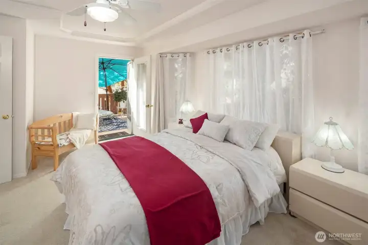 Upstairs primary bedroom with private balcony.