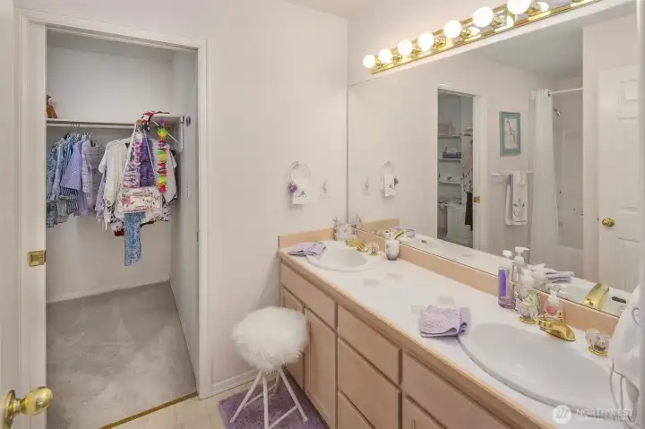 Ensuite bathroom with double vanity and walk in closet.