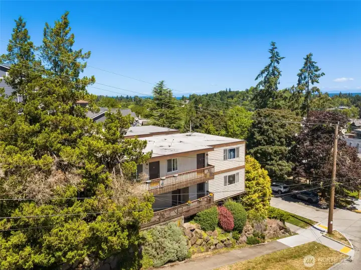 Mid-century multi-family building with classic flat-roof architecture and established landscaping Mid-century multi-family building with classic flat-roof architecture and established landscaping