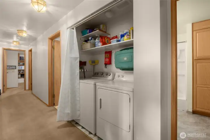 Central hallway configuration with built-in linen storage and utility closets. Central hallway configuration with built-in linen storage and utility closets.