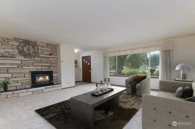 Large living room plus a separate family room with a two-sided fireplace. One is gas, one is wood-burning. Giant windows look out on your secluded, nearly 2-acre property.