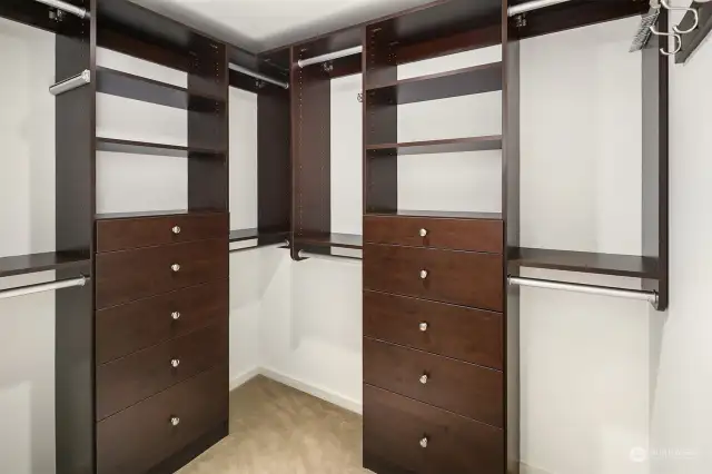 A large walk-in closet with custom shelving.