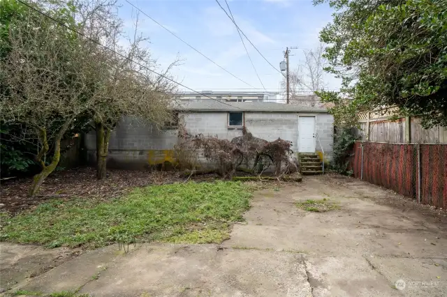 cinderblock garage spans the entire lot