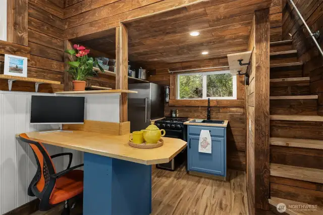 Stairs to upstairs to the right. "Desk" is great work space or easy prep for your meals.