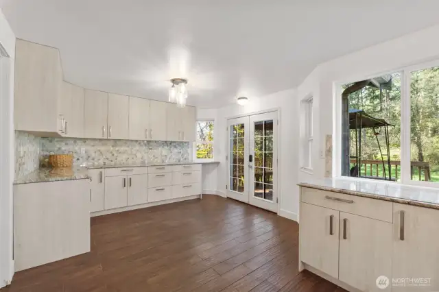 Off the formal dining area welcome to Chefs paradise. Exquisite tile backsplash, granite countertops, custom cabinets offering storage for days! Perfect spot for your kitchen table with access to the back deck.
