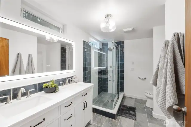 This private ensuite bath is freshly renovated. Gorgeous tile, dual vanity and glass shower.