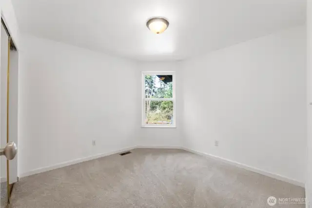 One of two spacious guest bedrooms located upstairs.
