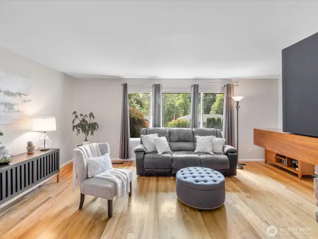 Real hardwood floors flow seamlessly throughout the home, adding warmth, character, and lasting durability.