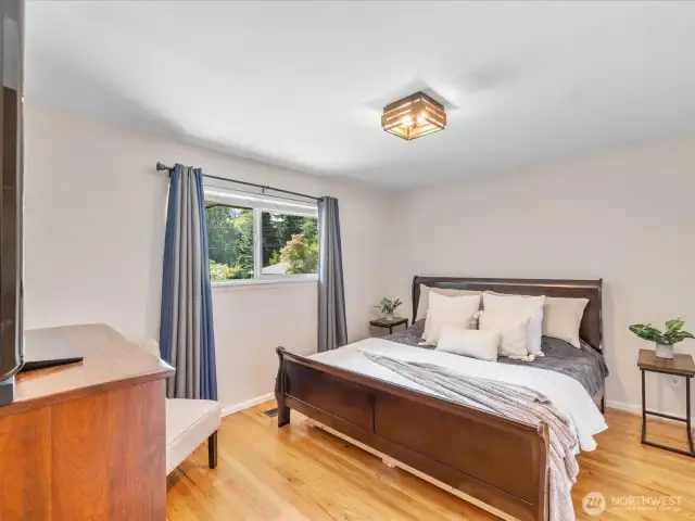 This large primary bedroom offers all the space you need to truly unwind, with plenty of room for your king-sized bed and full bedroom suite.