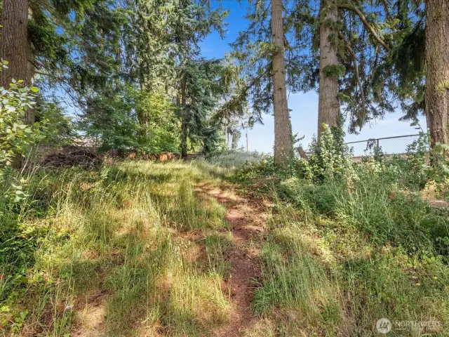 Just beyond the landscaped yard lies even more potential—clear a bit of the natural growth in the back, and you’ll uncover additional space to garden, play, or create your dream outdoor retreat.