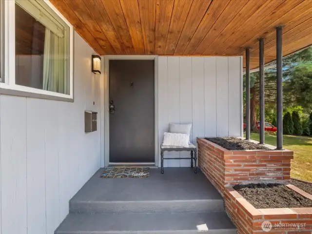 Welcome guests and enjoy quiet mornings on the charming covered front porch, beautifully accented with rich cedar detailing.