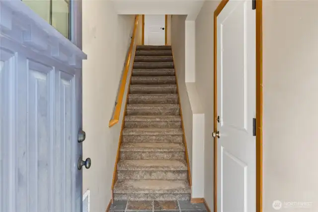 Granite entry with garage door off to the right and stairs to the main living area.