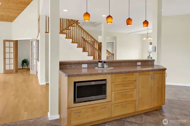 The kitchen features bar seating and a built-in microwave