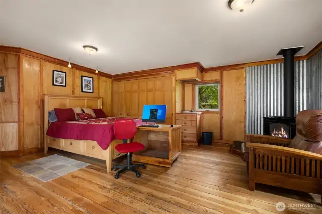 Main floor primary bedroom with built in wood closets, wood floors and propane fire place for cozy evenings.