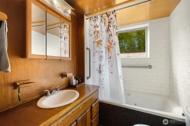 The main floor full bath is down the hall from the bedroom. They did not do "primary suites" in 1901.