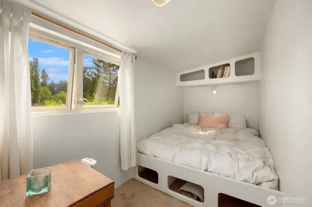 There are 3 small, I mean small bedrooms on the upper level and the stairs up are original 1901- small and tight. This is the first bedroom. Feels like a boat!