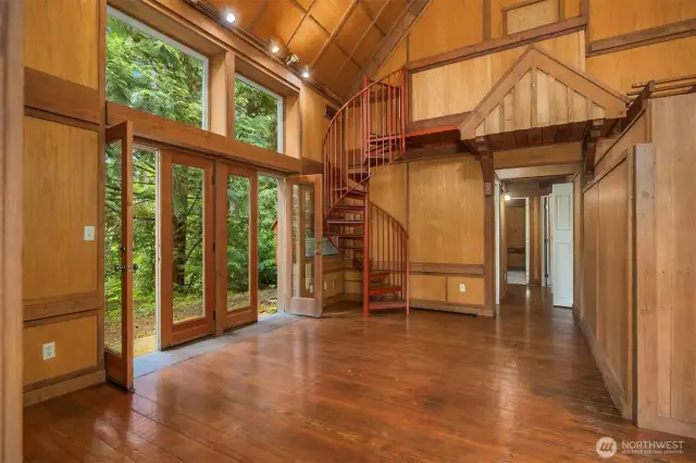 The 2nd home features a lot of natural wood finishes with glass doors leading to the side yard. The spiral stair case leads to unfinished storage only.