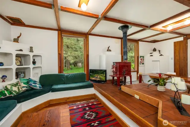 Box beam ceilings and wood burning stove add to the charm of this older home.