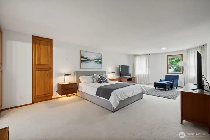 Virtually staged primary bedroom has two huge walk in closets