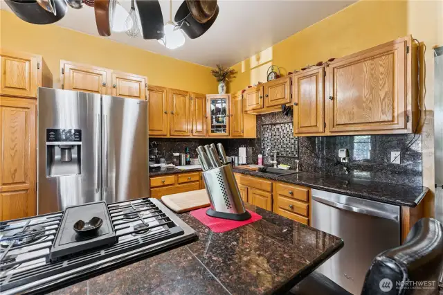 All stainless steel appliances & a gas range.