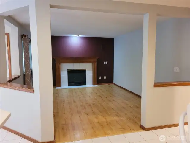 Family room with gas fireplace off the kitchen and views dinette. Beautiful hardwood floors