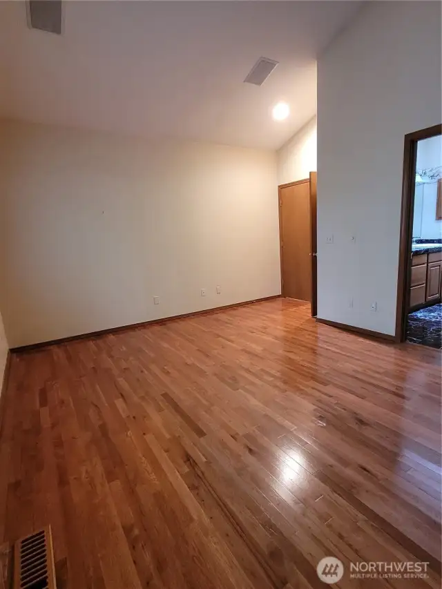 The Main floor master suite has rich hardwood floors, a 5 piece bathroom and walk in closet