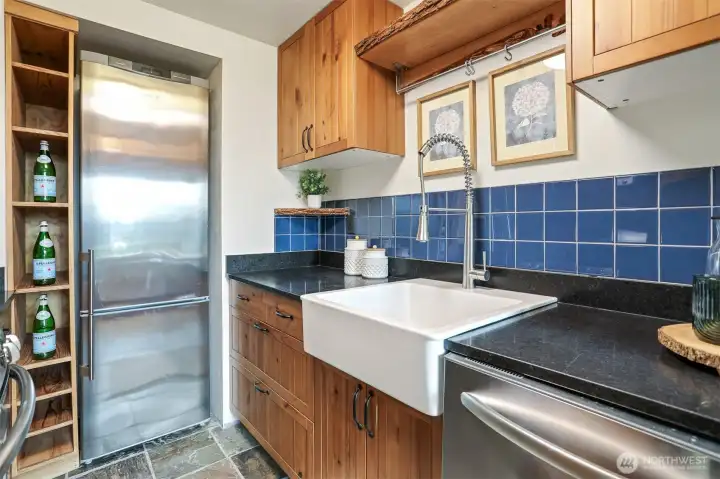 Remodeled kitchen features marble counter, tile floors, stainless appliance, live edge maple wood shelves,  gas range and cedar bump out for the refrigerator and shelving.