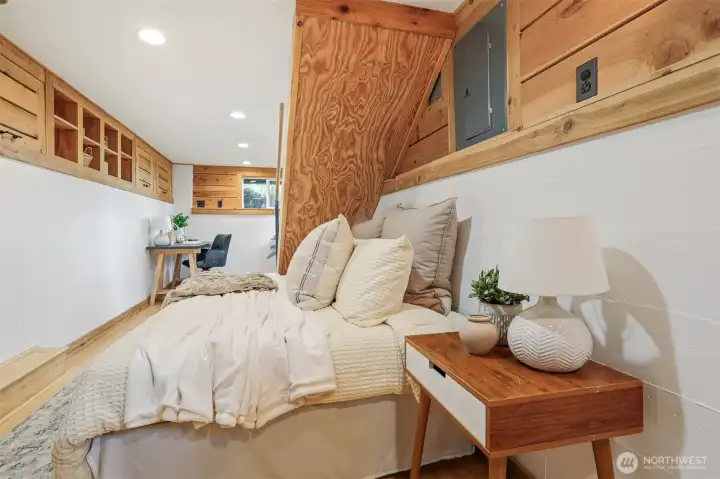 Lower level multi purpose living area:  office, bedroom, family room, etc.  Features:  bamboo floors, cedar built in storage and closet. Has a separate entry and 3/4 bathroom.