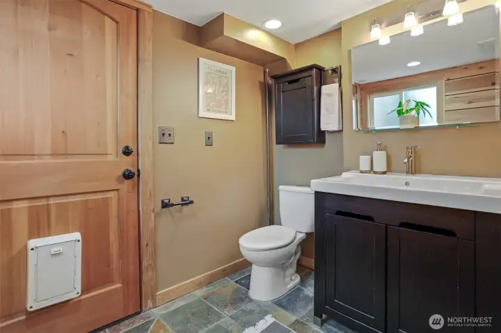 Lower level remodeled 3/4 tiled bathroom with heated stone floors and stone tiled shower.
