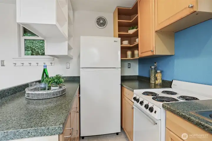 Cottage kitchen opens to living area.