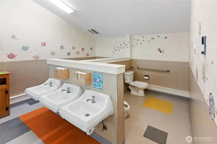 Behind the handwashing station.