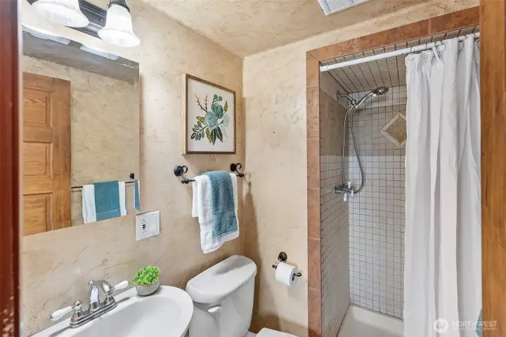 bathroom with shower tiled