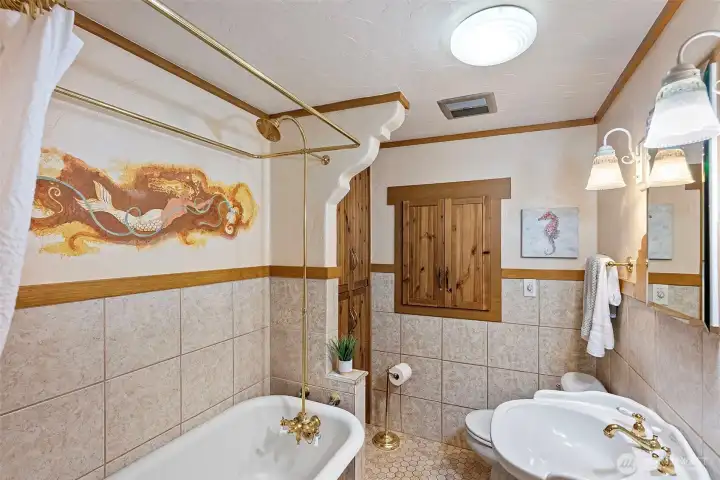 full bathroom with a Claw footed tub and built in cabinets