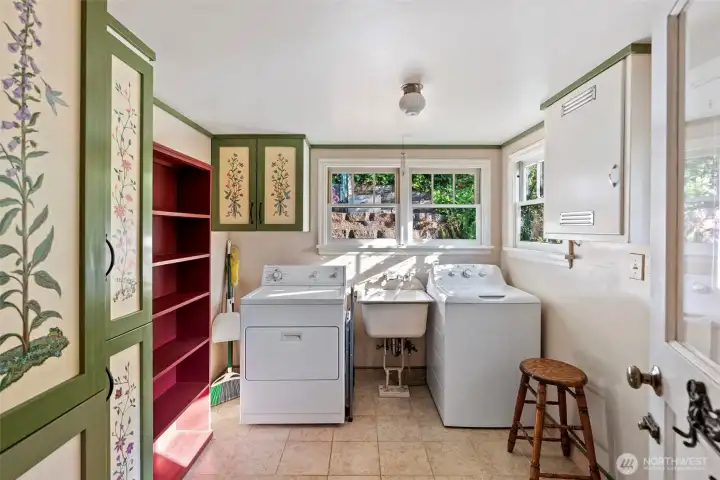 laundry room off of the kitchen built in hand painted cabinets