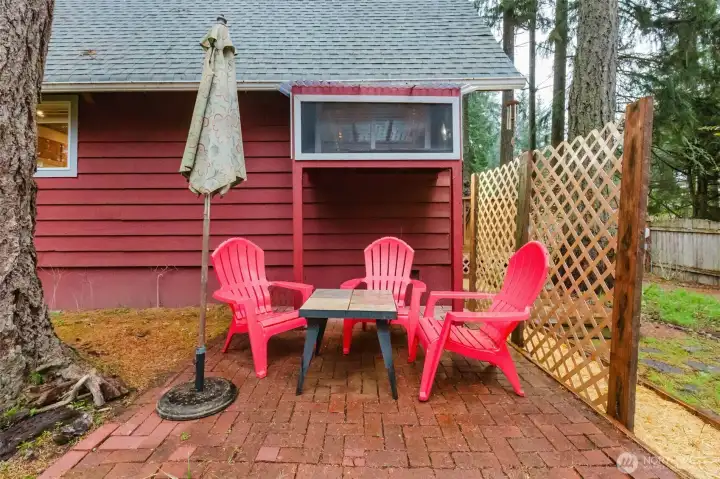 The brick patio invites moments of stillness—whether with a warm cup in hand or in simple relaxation.